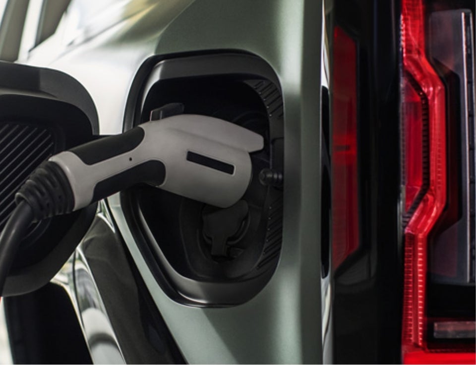 Close up of charging port with charger plugged in on a GMC Hummer EV SUV - Northside GMC in Summersville WV